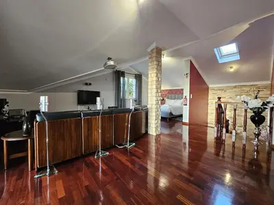 a living room with a hard wood floor and a kitchen at Villa River Ponta do Sol by Rentallido in Canhas