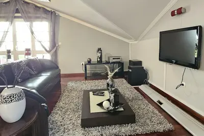 a living room with a couch and a flat screen tv at Villa River Ponta do Sol by Rentallido in Canhas