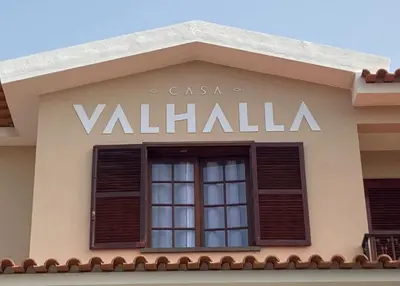 a sign on the side of a building with a window at Casa Valhalla in Funchal