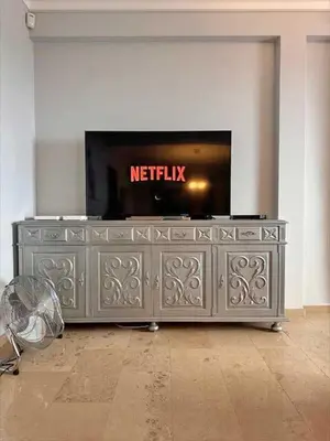 a metal entertainment center with a television on top of it at Casa Valhalla in Funchal