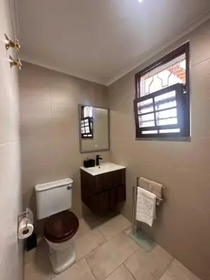 a bathroom with a toilet and a sink and a window at Casa Valhalla in Funchal