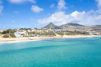 a view of a beach with mountains in the background at Fontinha by An Island Apart in Porto Santo