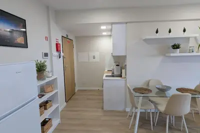 a kitchen and dining room with a table and chairs at Top-Floor One-Bedroom Flats - Peaceful with Ocean and City Views in Funchal