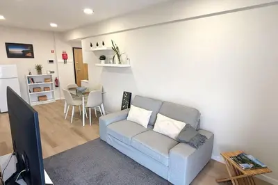 a living room with a couch and a table at Top-Floor One-Bedroom Flats - Peaceful with Ocean and City Views in Funchal