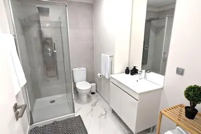 a bathroom with a shower and a toilet and a sink at Top-Floor One-Bedroom Flats - Peaceful with Ocean and City Views in Funchal