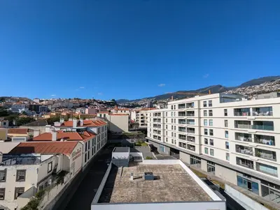 an aerial view of a city with buildings at Top-Floor One-Bedroom Flats - Peaceful with Ocean and City Views in Funchal