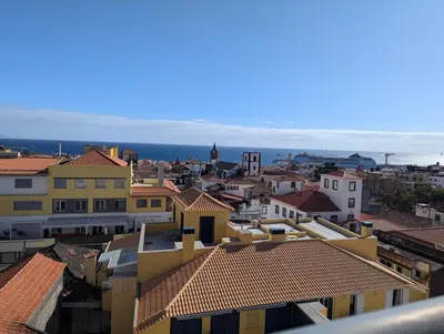 a view of a city with buildings and the ocean at Top-Floor One-Bedroom Flats - Peaceful with Ocean and City Views in Funchal