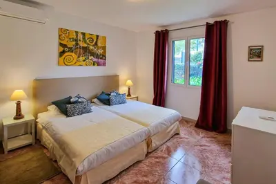 a bedroom with a large bed and a window at Villa Casa Amelia by Villa Plus in Caniço