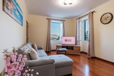 a living room with a couch and a tv at GuestReady - A charming experience in Madeira in Machico