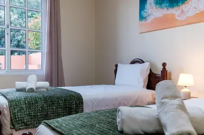 a bedroom with two beds and a window at GuestReady - A charming experience in Madeira in Machico