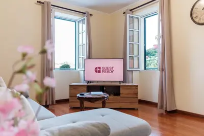 a living room with a couch and a tv on a table at GuestReady - A charming experience in Madeira in Machico