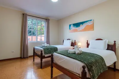 two beds with teddy bears on them in a bedroom at GuestReady - A charming experience in Madeira in Machico