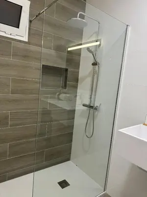 a shower with a glass door in a bathroom at Alforra Residence 2-Centro-Praias-Levadas in Câmara de Lobos