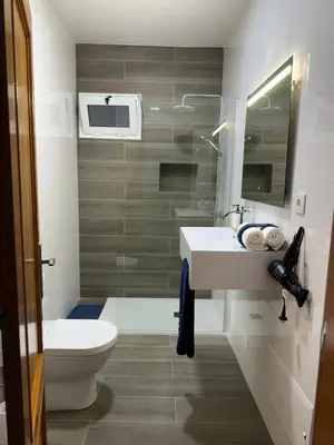 a bathroom with a white sink and a toilet at Alforra Residence 2-Centro-Praias-Levadas in Câmara de Lobos