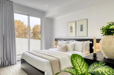 a bedroom with a large bed and a large window at Ribas Machico, a Home in Madeira in Machico