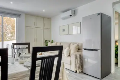 a kitchen and living room with a couch and a refrigerator at Ribas Machico, a Home in Madeira in Machico