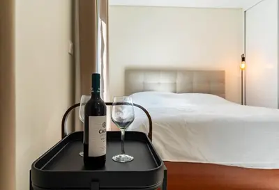 a bottle of wine and a wine glass on a suitcase at Terrace in Carmo in Funchal