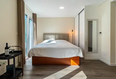 a bedroom with a large bed and a mirror at Terrace in Carmo in Funchal