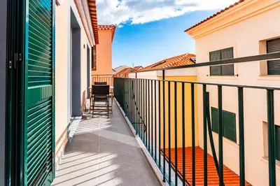 a balcony with a fence and chairs on it at Terrace in Carmo in Funchal