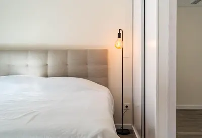 a bedroom with a white bed and a lamp at Terrace in Carmo in Funchal