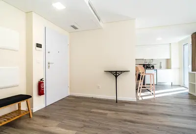 an open living room with white walls and wood floors at Terrace in Carmo in Funchal