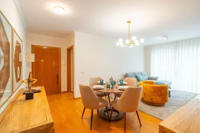 a living room with a table and a couch at Lux Girassol - Two Bedroom Apartment in Caniço