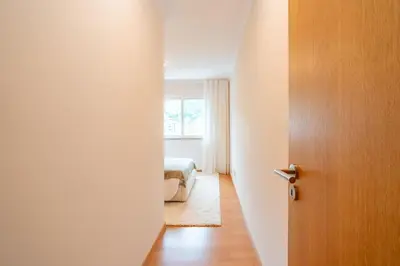an open door to a bedroom with a bed and a window at Lux Girassol - Two Bedroom Apartment in Caniço