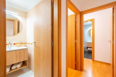 a bathroom with a sink and a mirror at Lux Girassol - Two Bedroom Apartment in Caniço