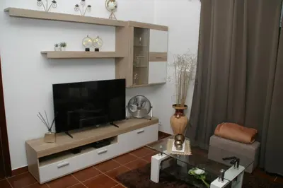 a living room with a flat screen tv on a wall at Casa do Prendinha B in Ponta do Pargo