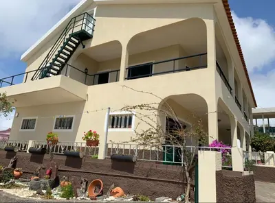 a white building with some plants in front of it at Casa do Prendinha B in Ponta do Pargo