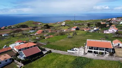an aerial view of a small village with houses and the ocean at Casa do Prendinha B in Ponta do Pargo