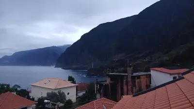 a view of a town with mountains and a body of water at Vivenda Silva in Seixal