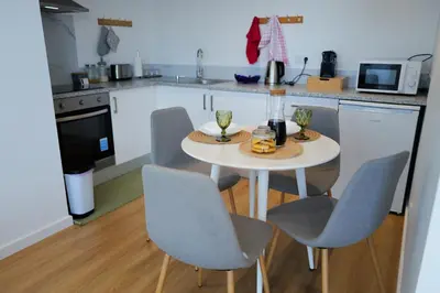 a kitchen with a table and chairs in a kitchen at Vivenda Silva in Seixal