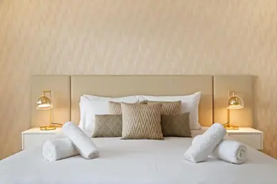 a bedroom with a white bed with two lamps at Sunset Vista 604 in Funchal