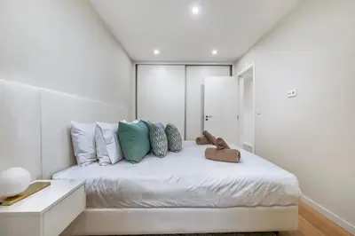 a white bedroom with a white bed with pillows at Sunset Vista 604 in Funchal