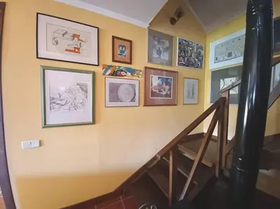 a room with a staircase and pictures on the wall at Casa da Lagoa BB or HB options in Santana