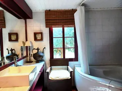 a bathroom with a tub and a sink and a bath tub at Casa da Lagoa BB or HB options in Santana