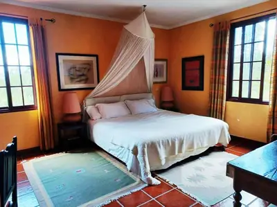 a bedroom with a bed with a canopy at Casa da Lagoa BB or HB options in Santana
