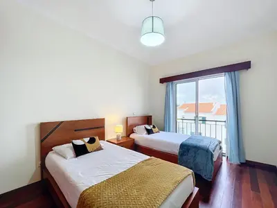 a hotel room with two beds and a window at Eddys House by Atlantic Holiday in Água de Pena