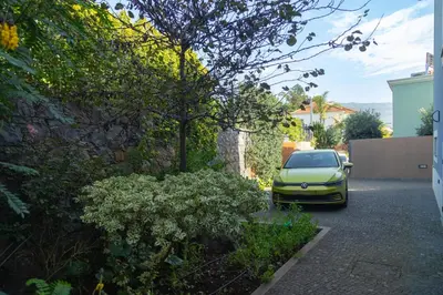 a yellow car parked in a parking lot at Villa Eden Sky in Prazeres in Prazeres