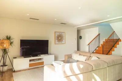 a living room with a couch and a flat screen tv at Villa Eden Sky in Prazeres in Prazeres
