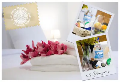 a bouquet of pink flowers in a vase on a table at Casa Caromba, Sunrise in Prazeres