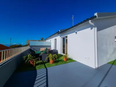 a white door on a balcony with plants at Casa Caromba, Sunrise in Prazeres