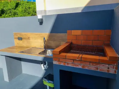 a model kitchen with a sink and a counter at Casa Caromba, Sunrise in Prazeres