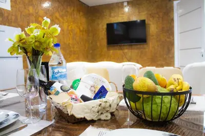 a table with a bowl of fruit and a bottle of water at Casa Caromba, Sunrise in Prazeres