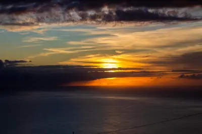 a sunset over a body of water with the ocean at Casa Caromba, Sunrise in Prazeres