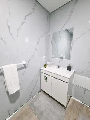 a white bathroom with a sink and a mirror at Casa Caromba, Sunrise in Prazeres