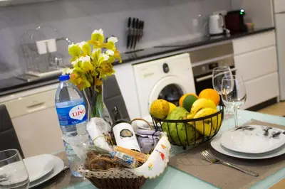 a table with a bowl of fruit and a bottle of water at Casa Caromba, Sunset in Prazeres