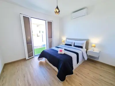 a bedroom with a bed with a blue and white bedspread at Casa Caromba, Sunset in Prazeres