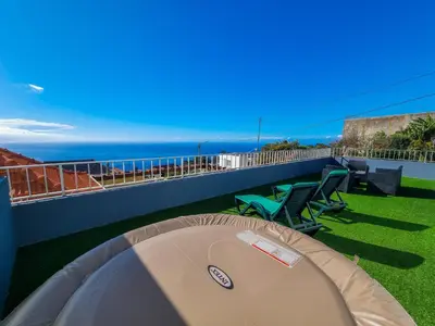 a view of the ocean from the balcony of a house at Casa Caromba, Sunset in Prazeres